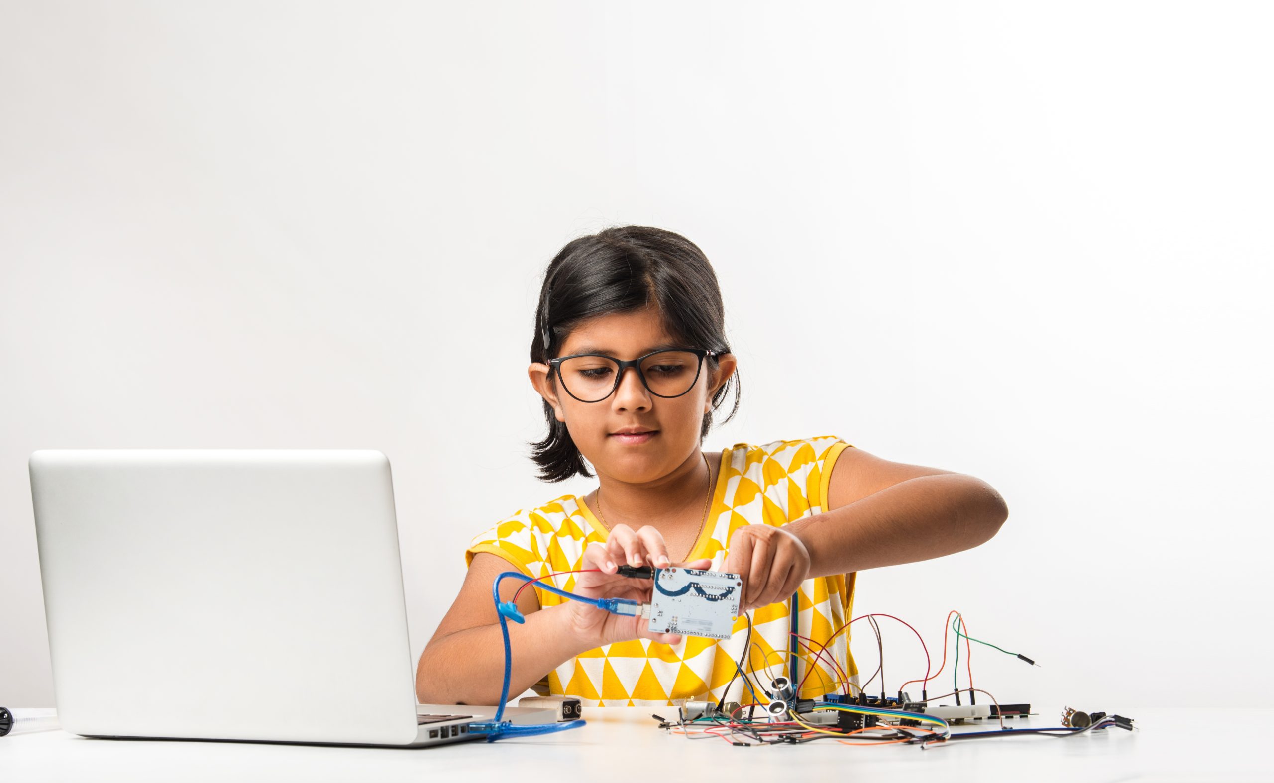 Indian girl creating something through electronic experiment